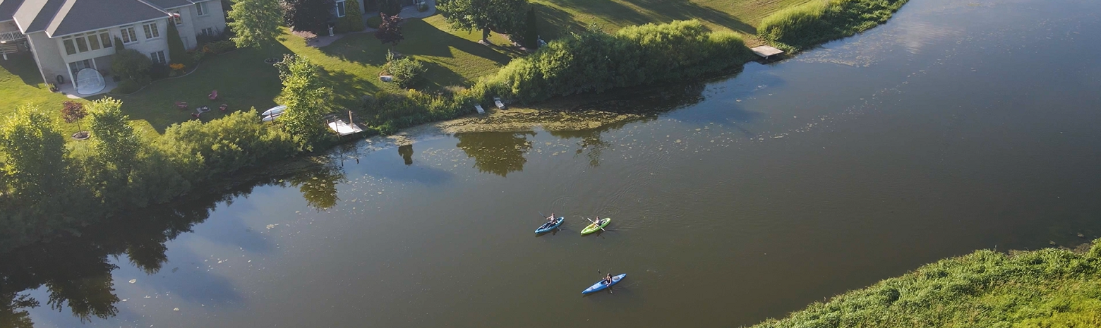 A picture of three people kayaking down the Maitland River in Brussels. 
