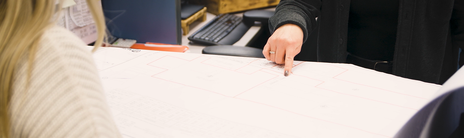 A picture of a staff member pointing to a map.