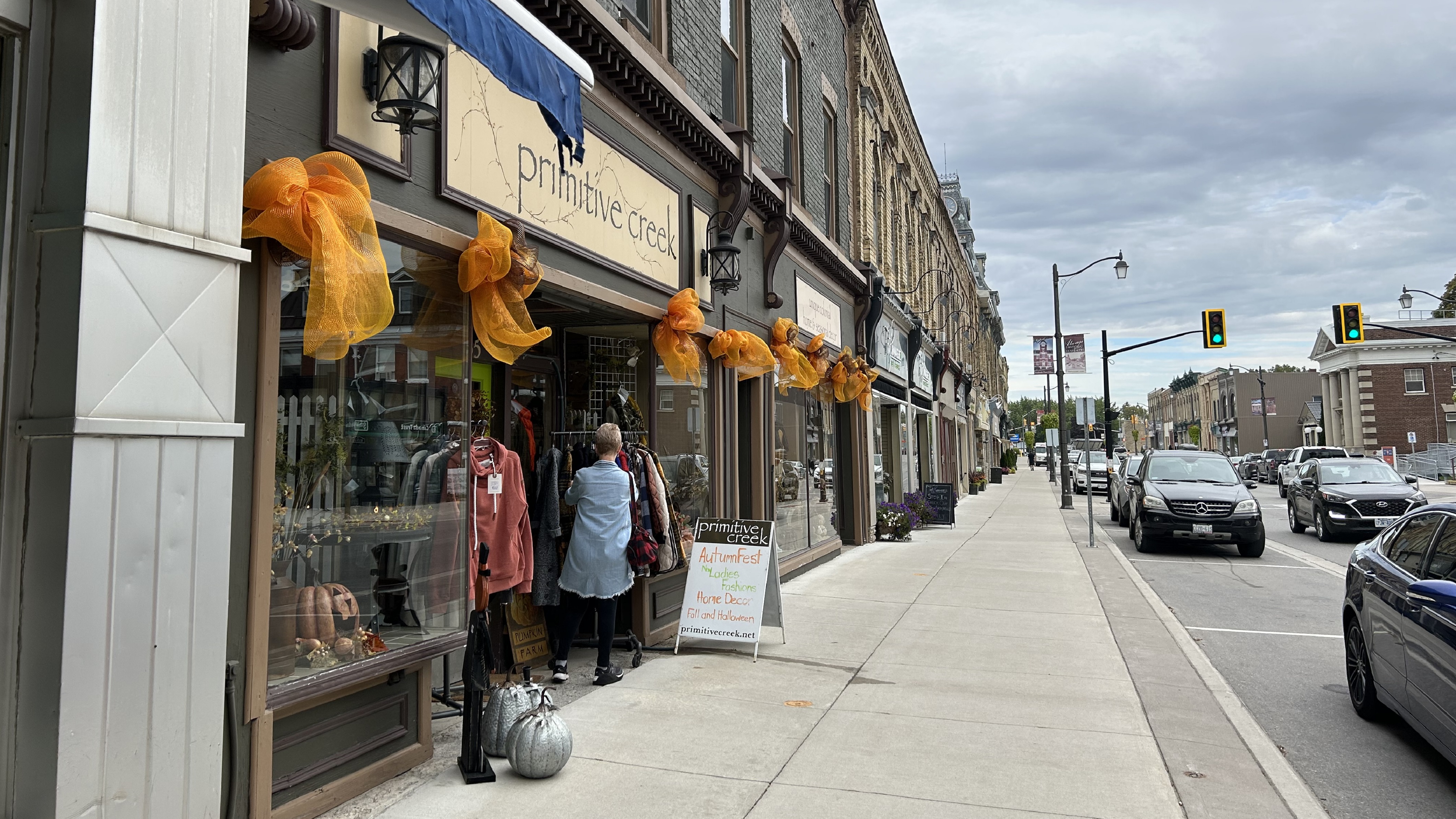A woman looking at clothes on an outdoor clothes rack in downtown Seaforth.
