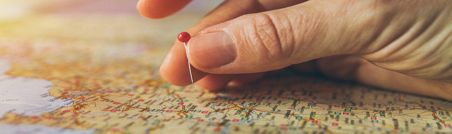 Hand pinning a spot on map