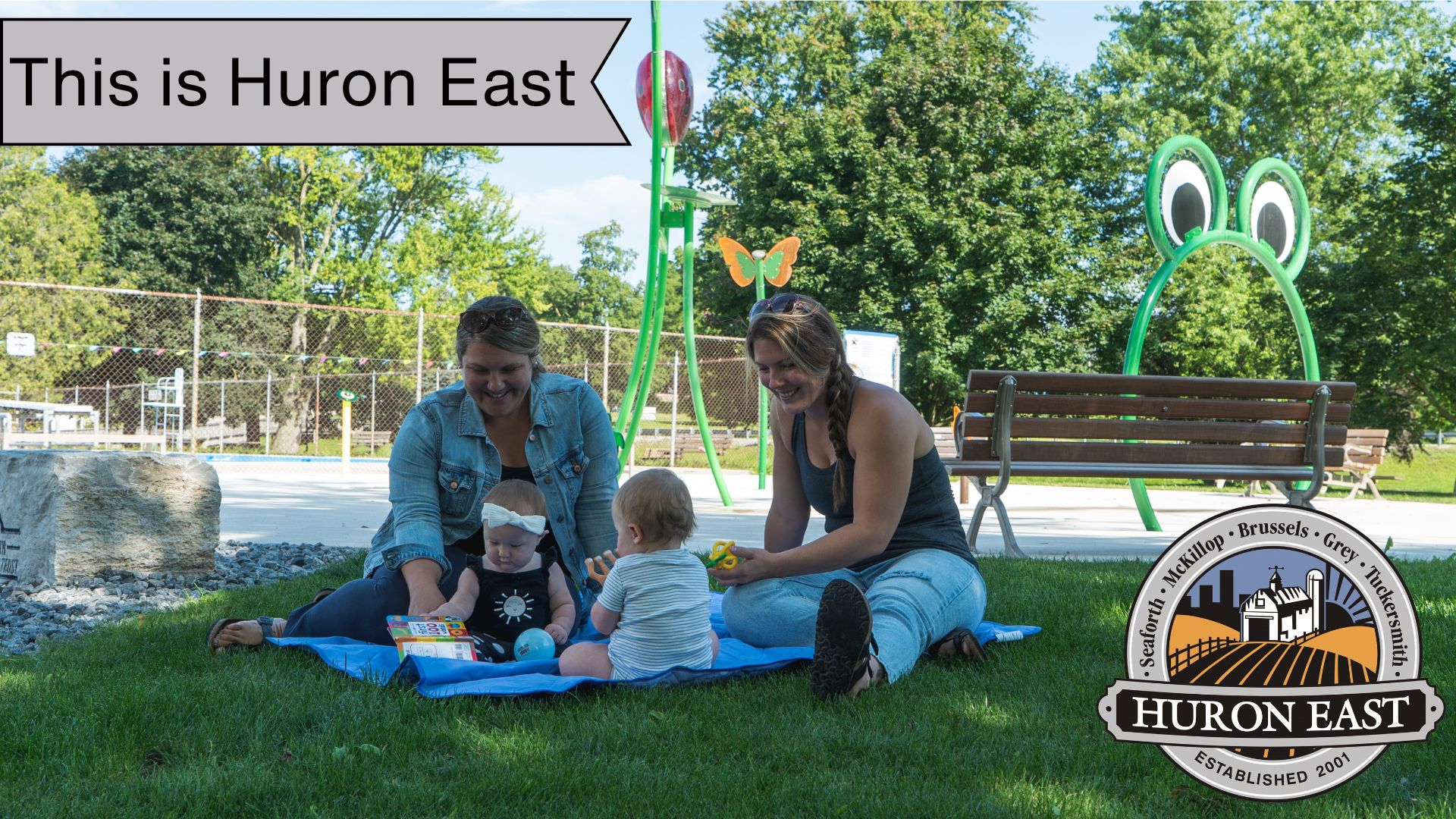 A picture of two moms and their babies at the Seaforth Splash Pad.